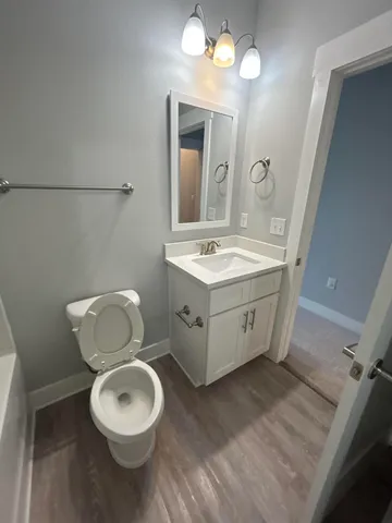 a bathroom with a toilet sink and mirror