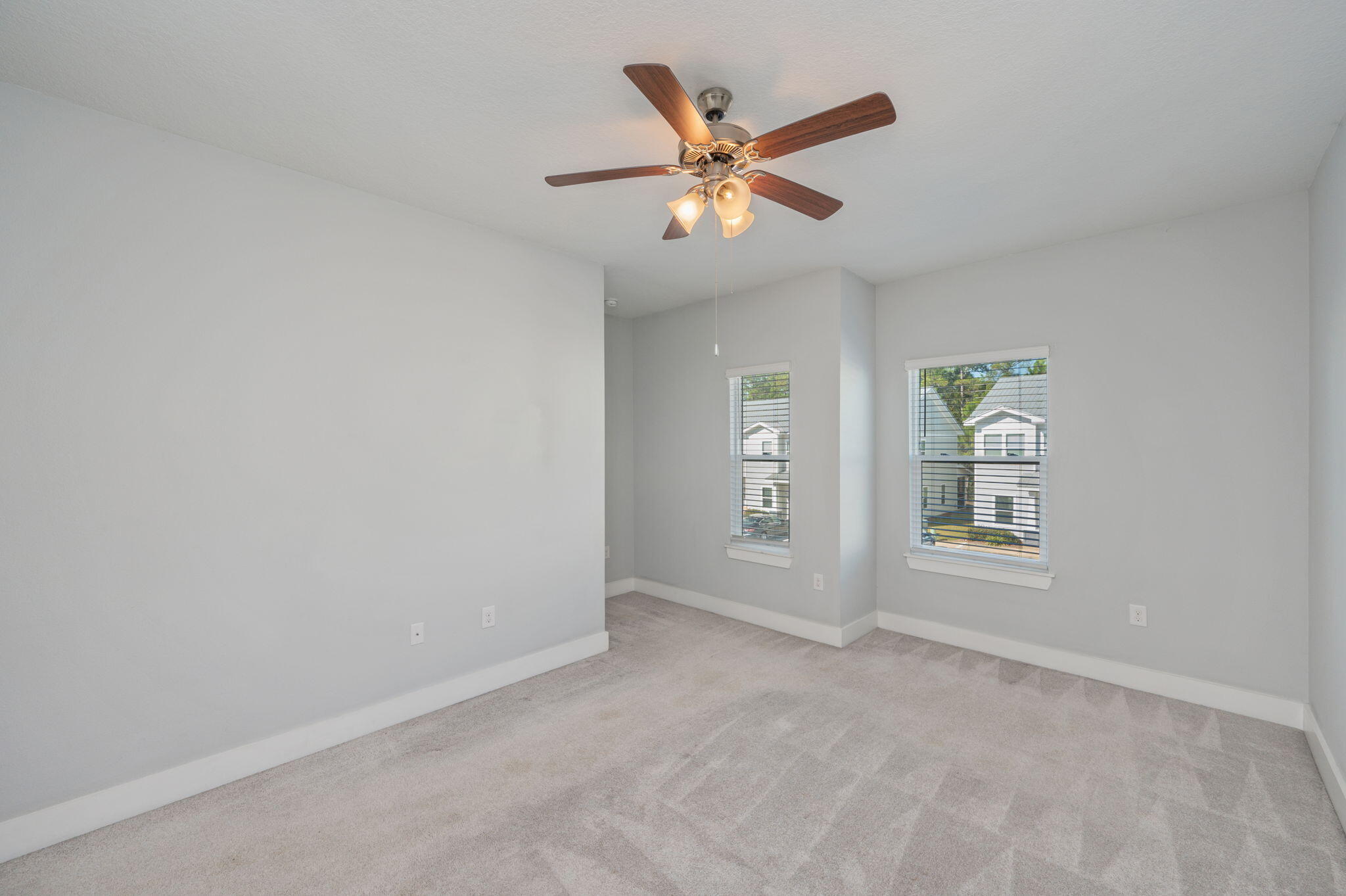 147 North Sand Palm Road Freeport, FL 32439 - Photo 22 of 39 an empty room with windows and fan