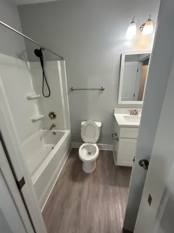 a bathroom with a granite countertop toilet a sink and a bathtub