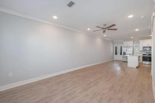 a view of kitchen with furniture and refrigerator
