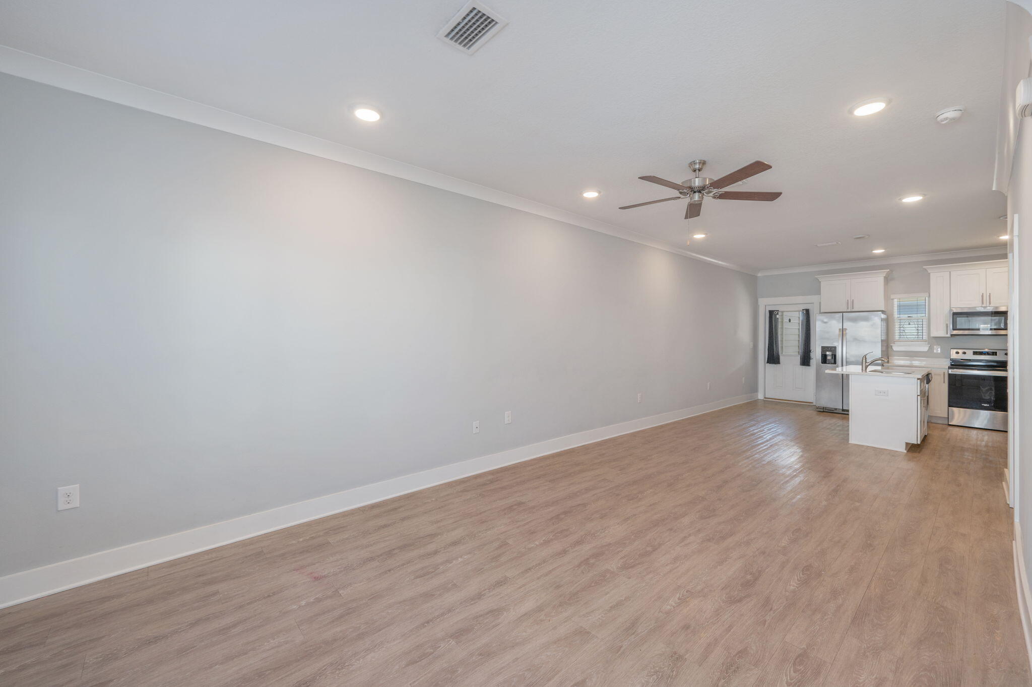 147 North Sand Palm Road Freeport, FL 32439 - Photo 7 of 39 an empty room with wooden floor and windows