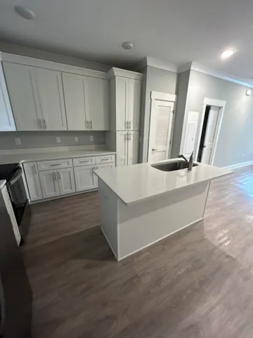 a large white kitchen with a sink