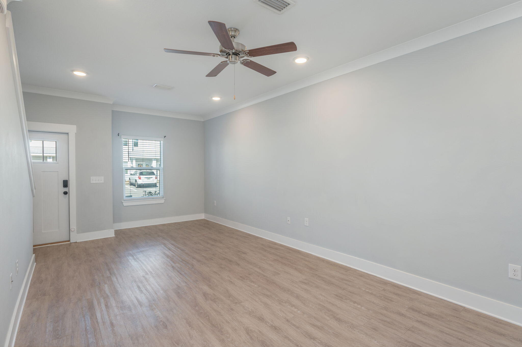 147 North Sand Palm Road Freeport, FL 32439 - Photo 10 of 39 wooden floor in an empty room with a window