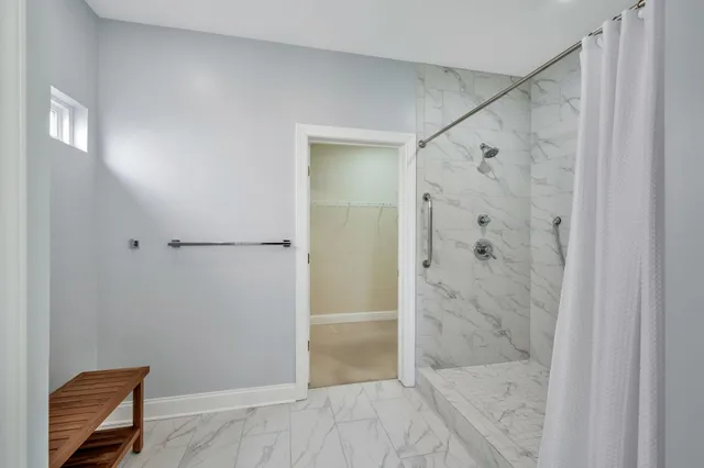 a bathroom with a glass shower door and a sink