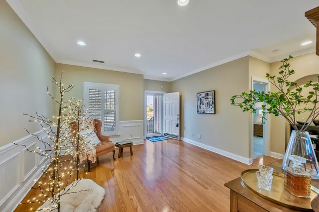a living room with furniture dining room and a chandelier