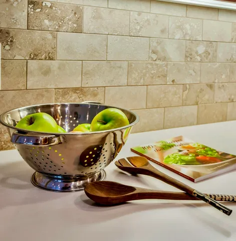 a kitchen with granite countertop wooden cabinets and stainless steel appliances