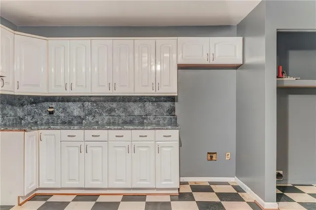 a view of a house with a yard and roof