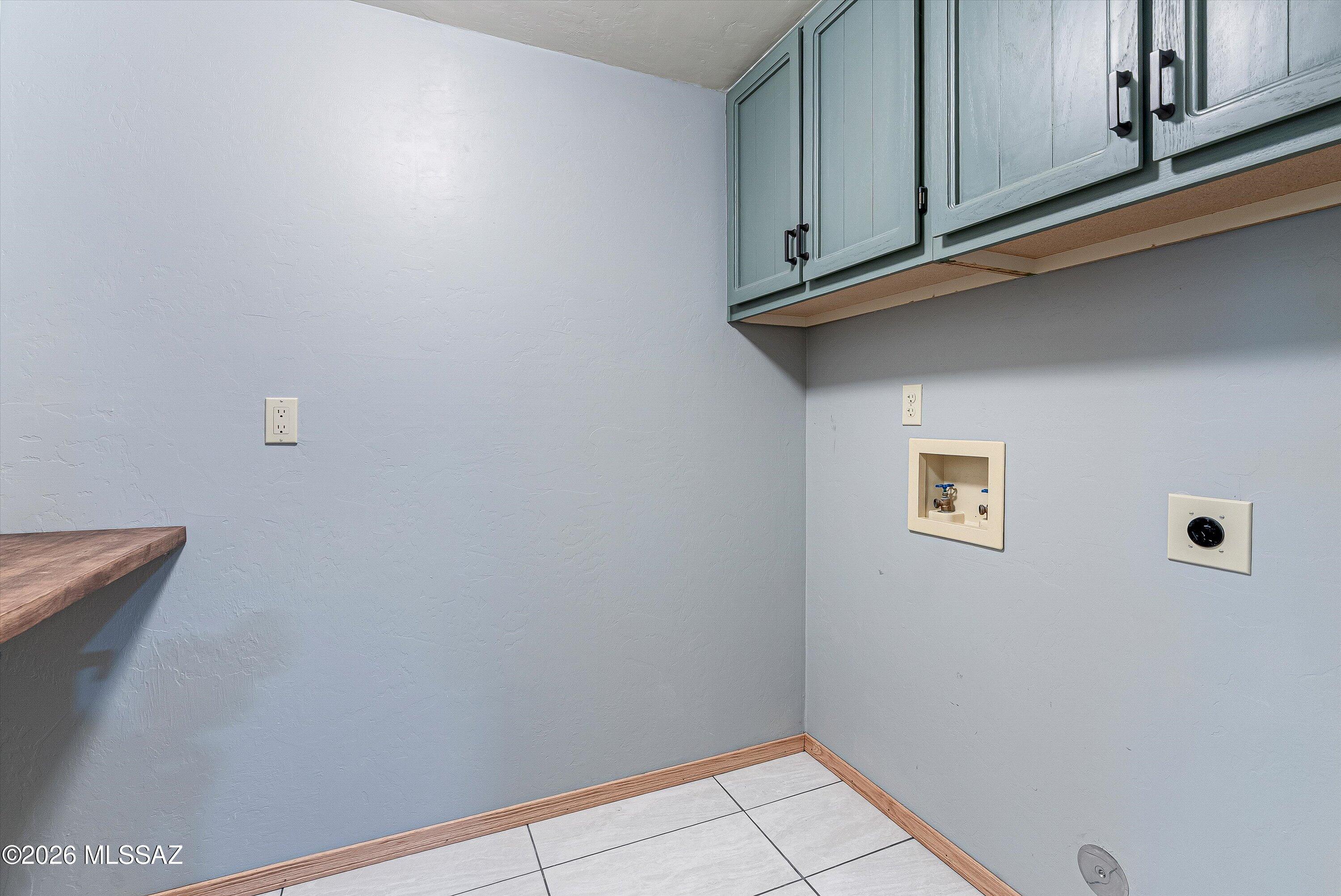 100 North Eastern Slope Loop Tucson, AZ 85748 - Photo 15 of 37 The nicely sized laundry room offers storage and built-in countertop for all of your folding needs.