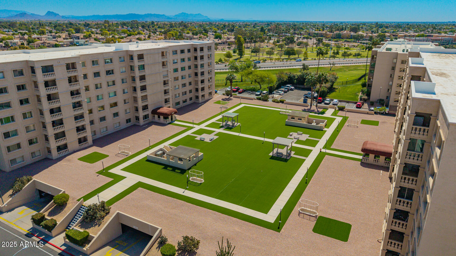 7910 East Camelback Road, Unit 104 Scottsdale, AZ 85251 - Photo 15 of 38 an aerial view of a pool and chairs
