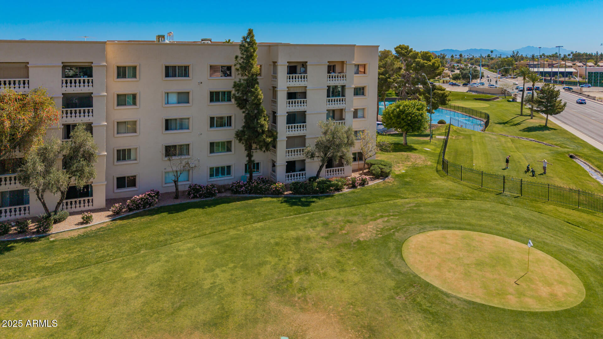 7910 East Camelback Road, Unit 104 Scottsdale, AZ 85251 - Photo 18 of 38 front view of a building with a swimming pool