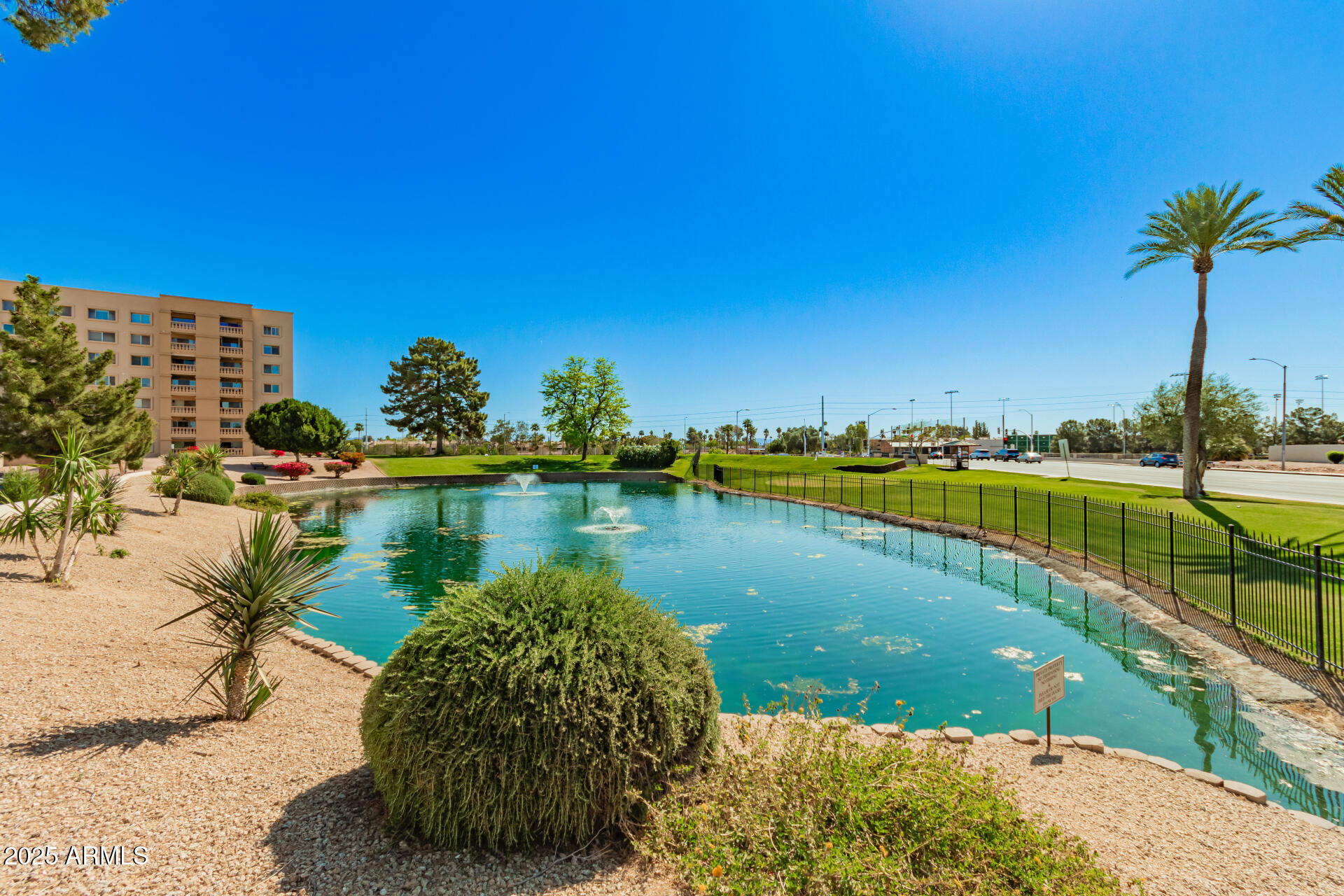 7910 East Camelback Road, Unit 104 Scottsdale, AZ 85251 - Photo 9 of 38 a view of a lake with a yard