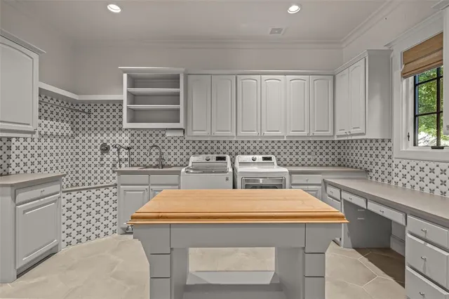 a kitchen with a sink a stove and cabinets