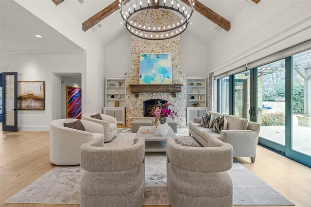 a living room with furniture a fireplace and a large window