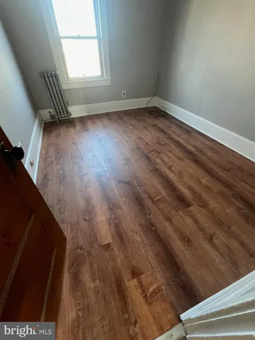 a view of room with window and hardwood floor