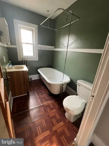 a bathroom with a toilet sink and mirror