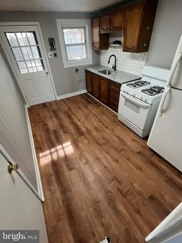 a kitchen with a stove a sink and a microwave