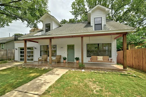 a house view with a sitting space and garden space