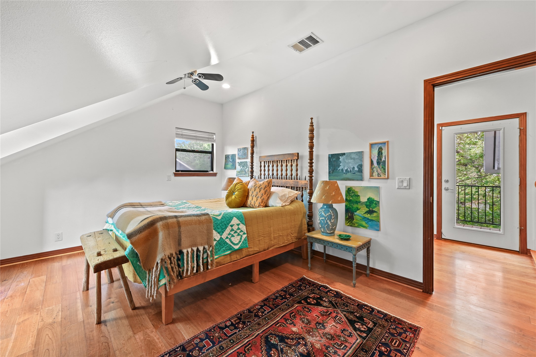 2107 East 13th Street Austin, TX 78702 - Photo 17 of 25 a bedroom with a bed and wooden floor