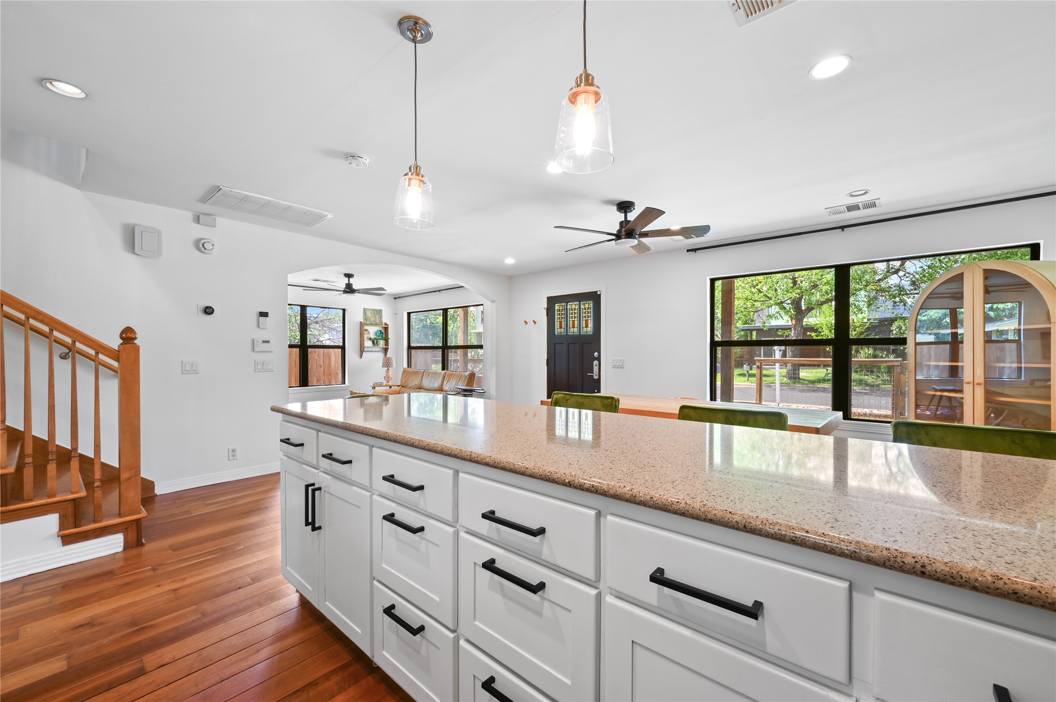 2107 East 13th Street Austin, TX 78702 - Photo 8 of 25 a open kitchen with stainless steel appliances granite countertop a sink a oven a dining table and chairs with wooden floor