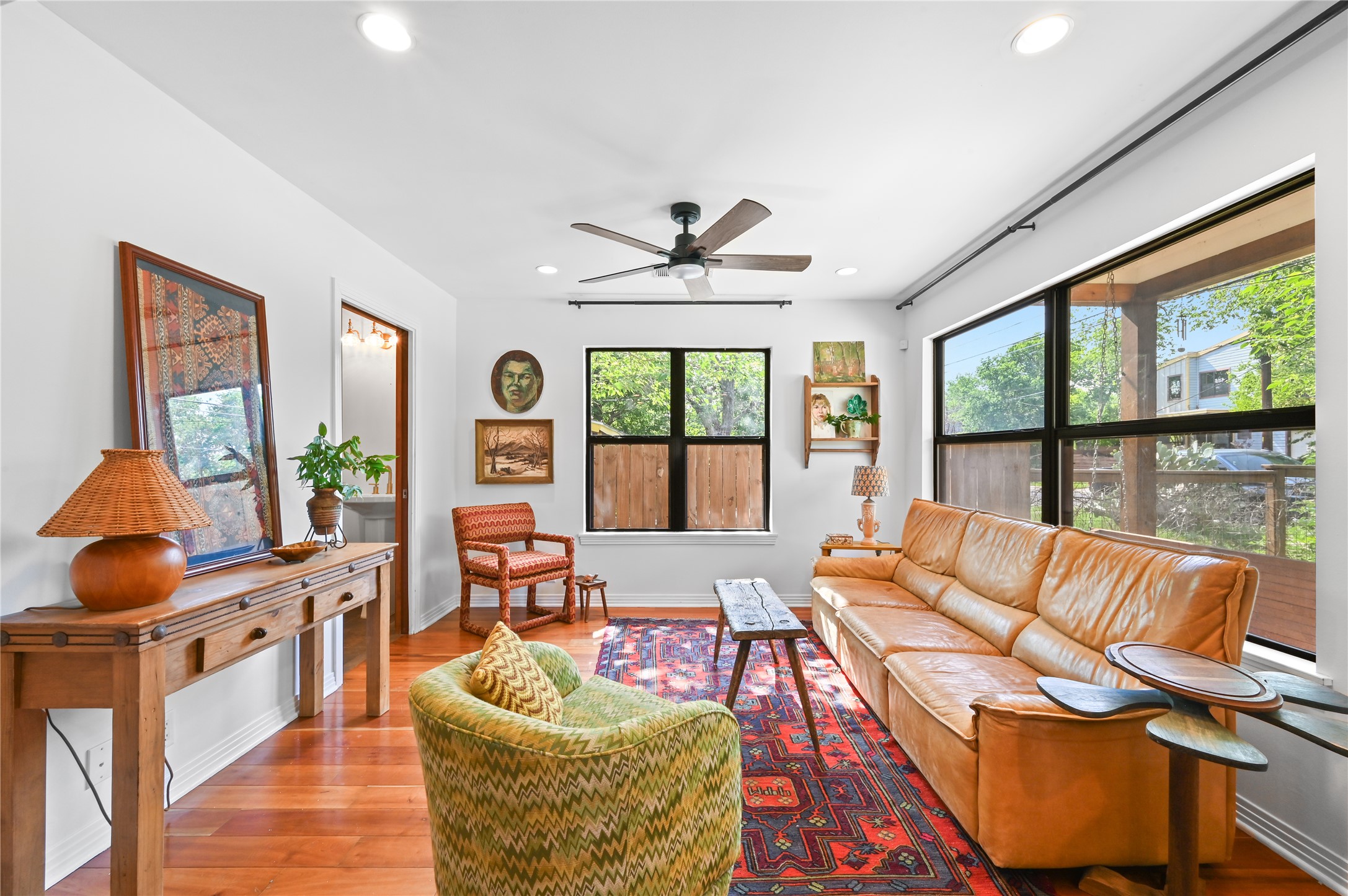 2107 East 13th Street Austin, TX 78702 - Photo 9 of 25 a living room with furniture floor to ceiling window and a flat screen tv