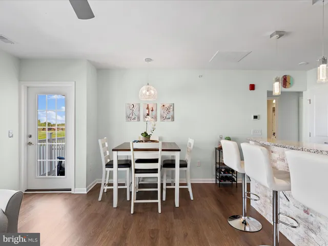a view of kitchen with stainless steel appliances granite countertop cabinets and wooden floor
