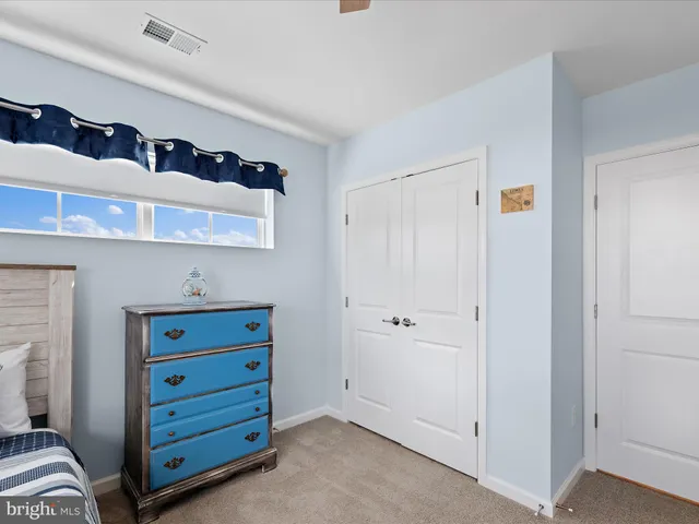 a bedroom with bed and a window