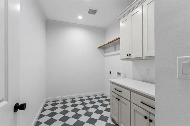 a view of a kitchen with white cabinets