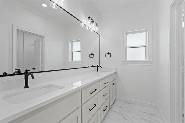 a bathroom with a double vanity sink and mirror