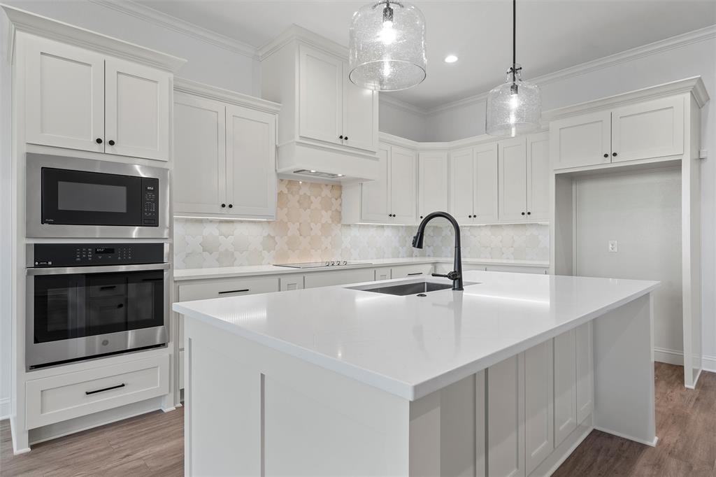 2113 Holborn Street Lorena, TX 76655 - Photo 7 of 31 a kitchen with white cabinets and stainless steel appliances