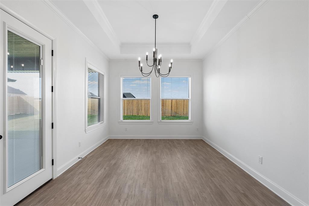 2113 Holborn Street Lorena, TX 76655 - Photo 10 of 31 a view of a room with wooden floor chandelier and windows