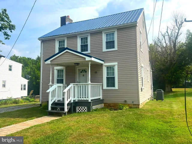 a front view of a house with a yard glass top table and chairs