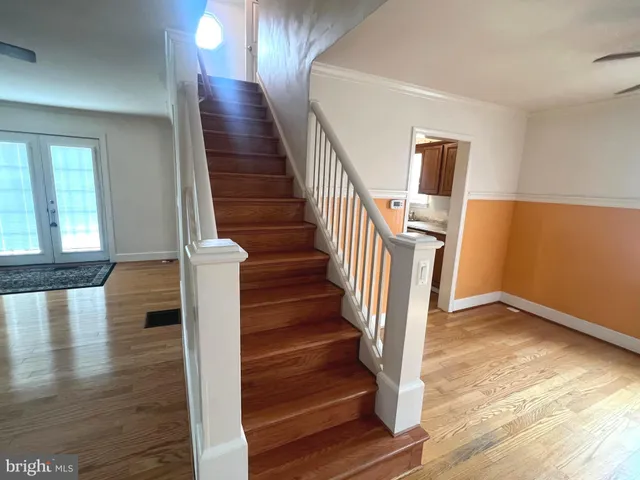 a view of entryway and hall with wooden floor