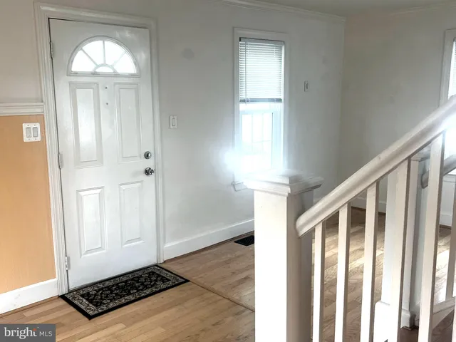 a view of a livingroom with wooden floor and a window