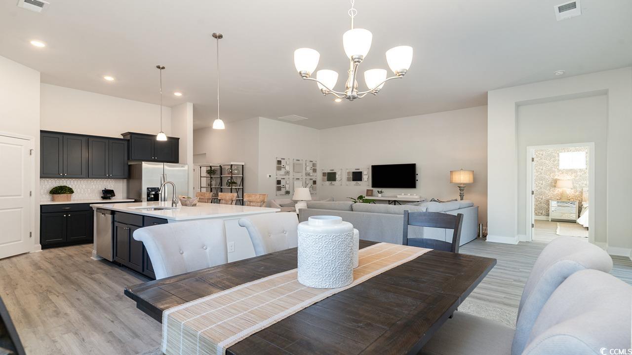 803 Ireland Drive Longs, SC 29568 - Photo 20 of 26 Dining room with sink, a chandelier, and light har