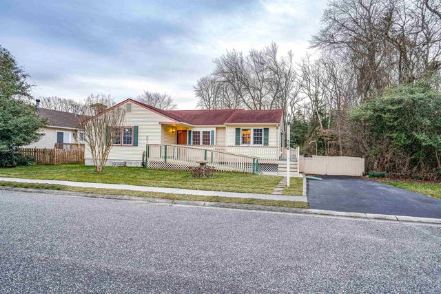 a view of house with outdoor space and sitting area