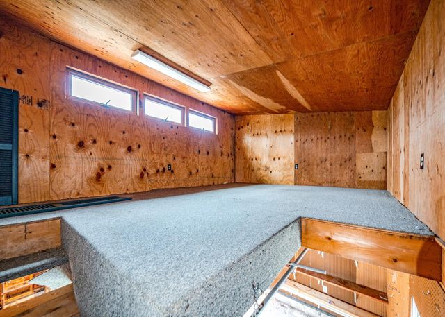 a view of a field with trees in the background