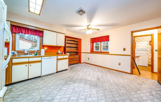 a kitchen with stainless steel appliances granite countertop a sink and cabinets