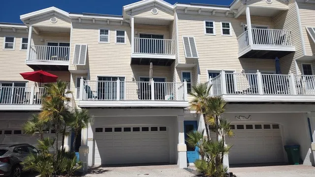 a front view of white house with a yard