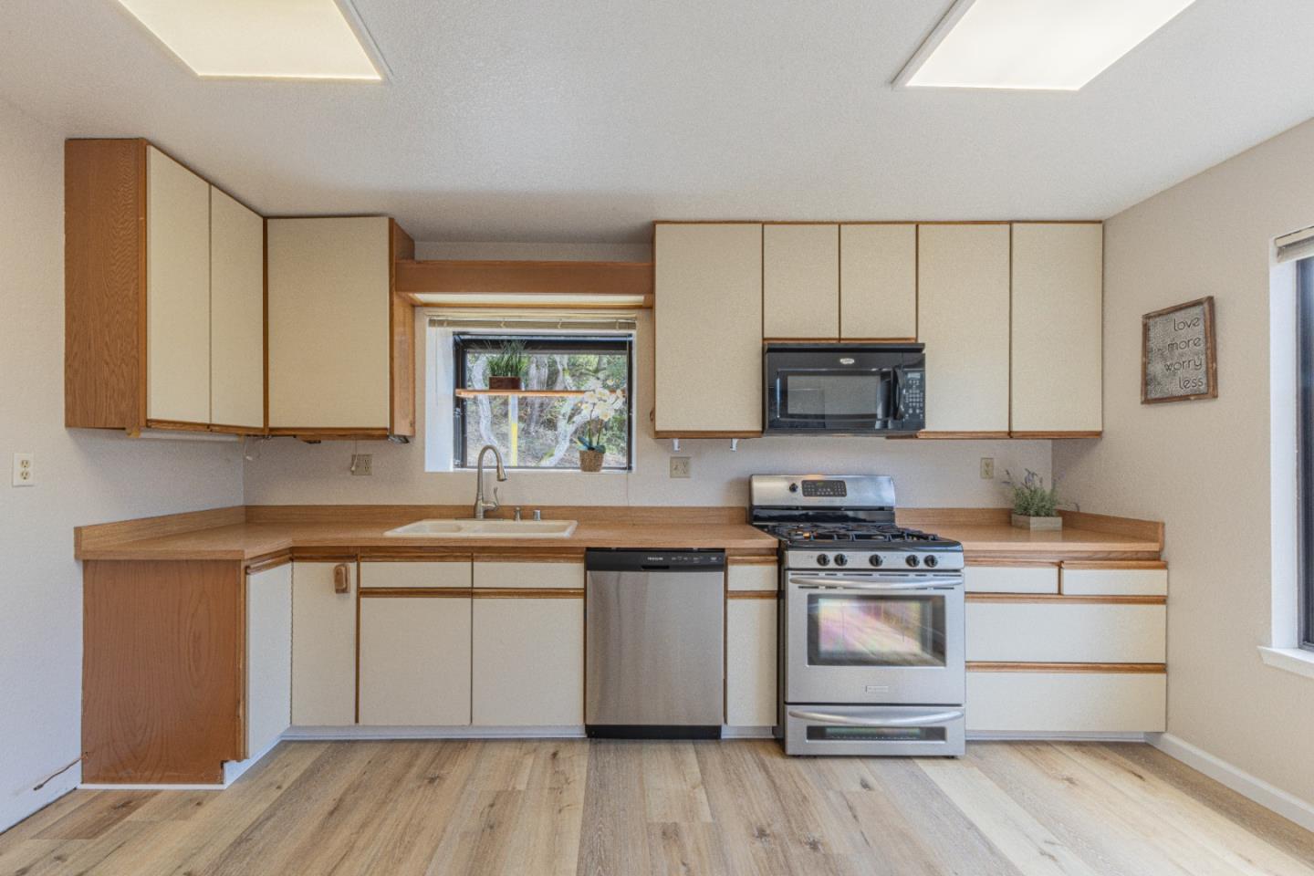 6959 Valle Pacifico Road Salinas, CA 93907 - Photo 15 of 45 a kitchen with stainless steel appliances a stove a sink and white cabinets