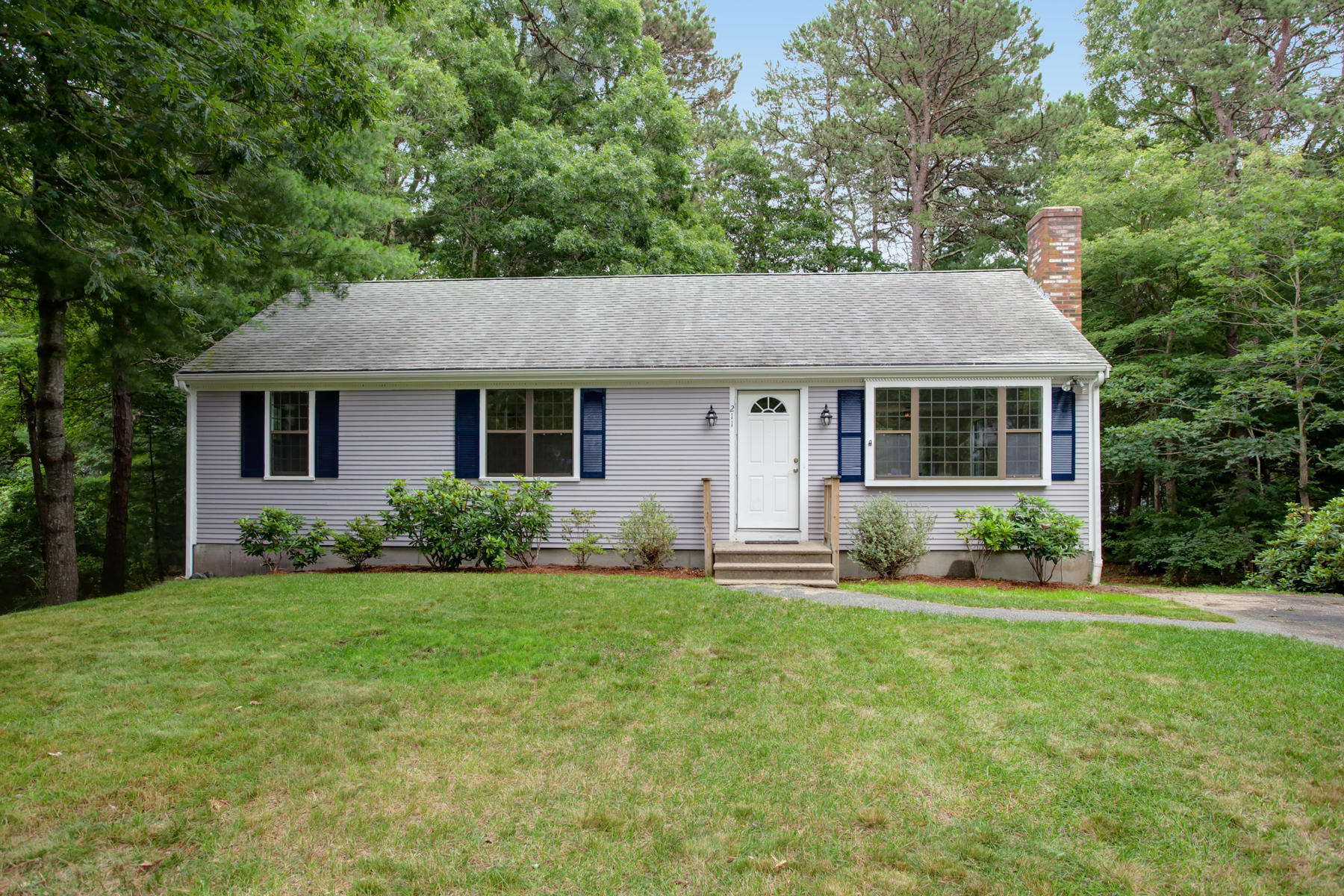 211 Oldham Road Osterville, MA 02655 - Photo 1 of 26 a front view of a house with a yard