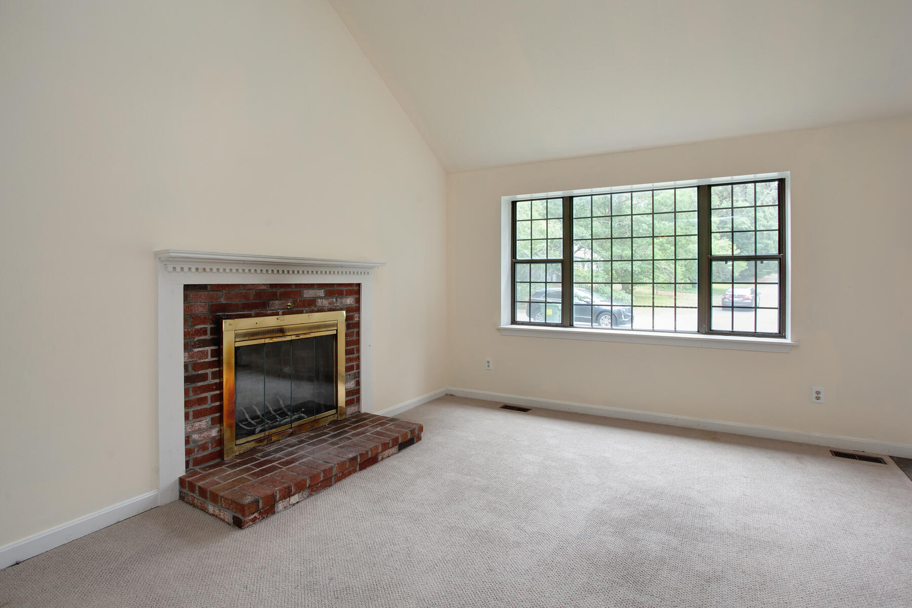 211 Oldham Road Osterville, MA 02655 - Photo 4 of 26 an empty room with fireplace and windows