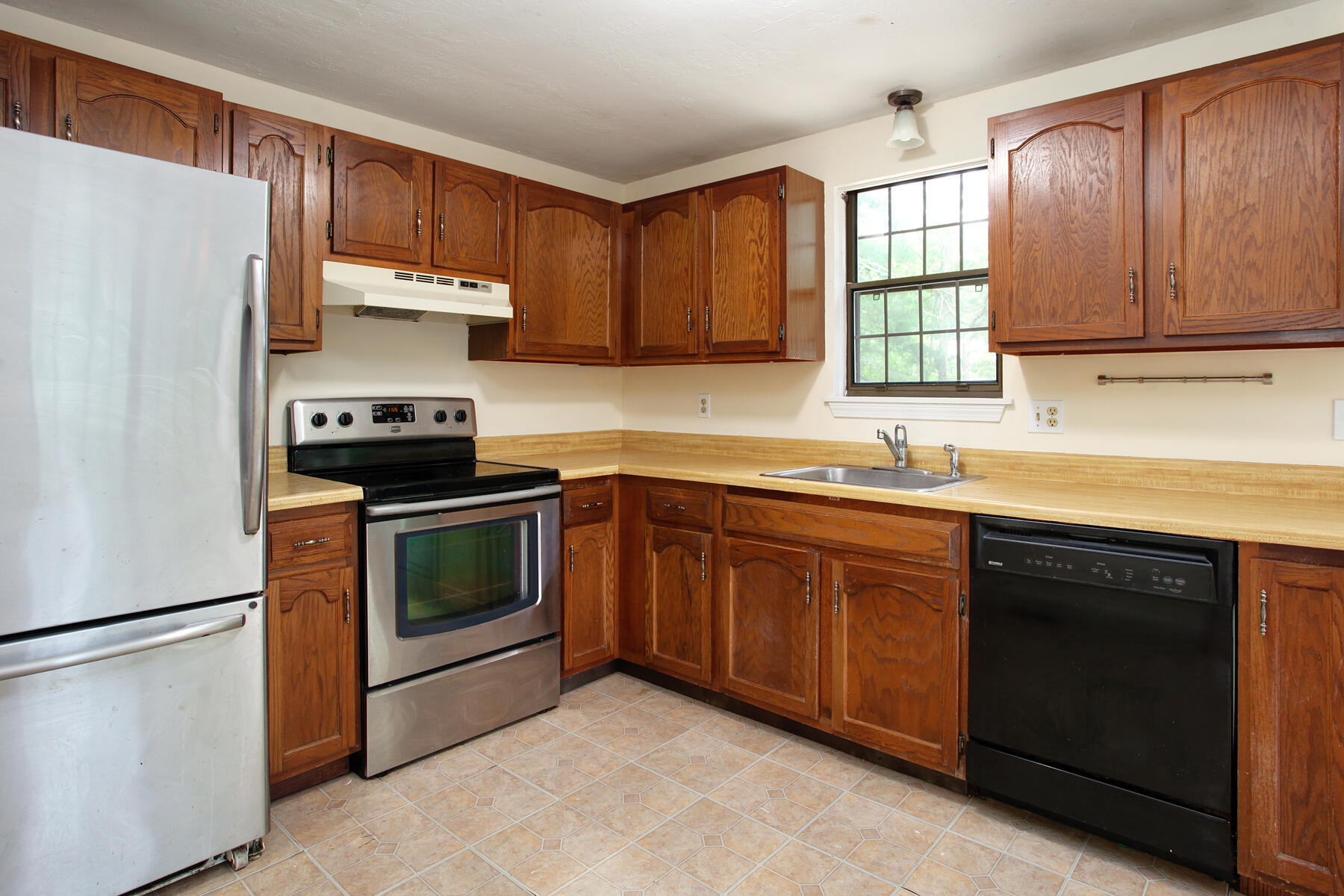 211 Oldham Road Osterville, MA 02655 - Photo 8 of 26 a kitchen with stainless steel appliances granite countertop a refrigerator stove a sink dishwasher and microwave