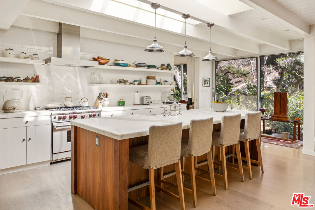 830 Brooktree Road Pacific Palisades, CA 90272 - Photo 12 of 37 a kitchen with a sink and chairs
