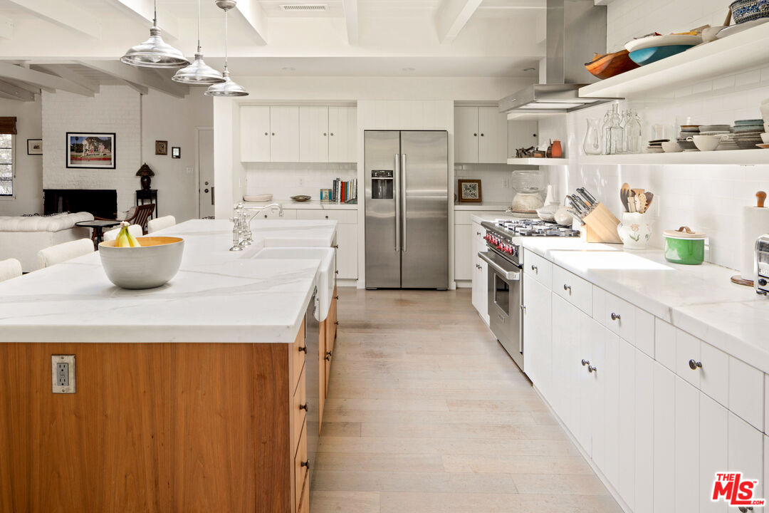 830 Brooktree Road Pacific Palisades, CA 90272 - Photo 16 of 37 a kitchen with a white stove top oven and cabinets