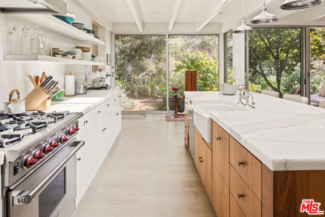 830 Brooktree Road Pacific Palisades, CA 90272 - Photo 18 of 37 a large kitchen with stainless steel appliances granite countertop a sink and a stove