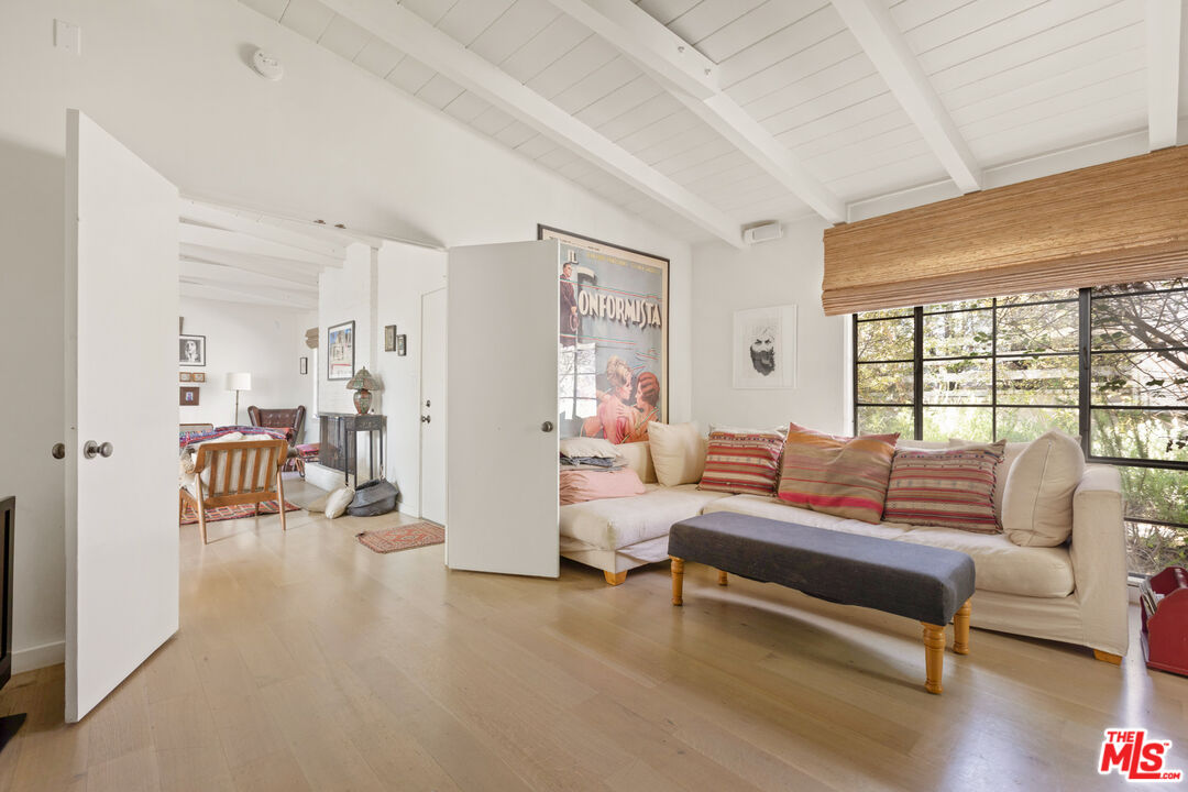 830 Brooktree Road Pacific Palisades, CA 90272 - Photo 20 of 37 a living room with furniture and a table with wooden floor