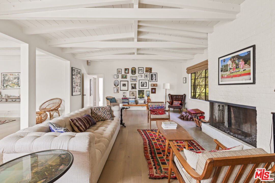 830 Brooktree Road Pacific Palisades, CA 90272 - Photo 8 of 37 a living room with furniture and a fireplace