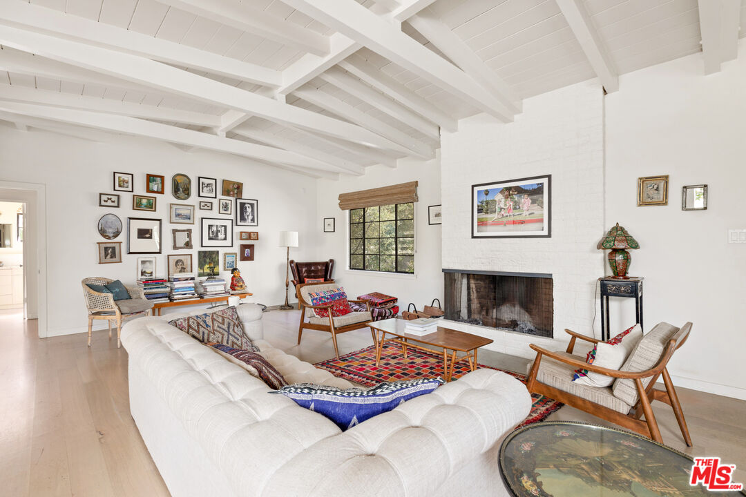 830 Brooktree Road Pacific Palisades, CA 90272 - Photo 9 of 37 a living room with furniture and a fireplace
