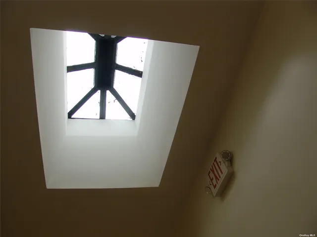 a view of a dining room with furniture and a chandelier