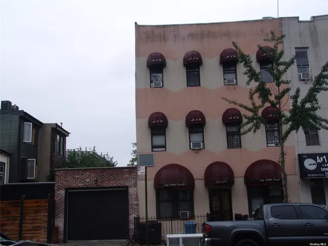a front view of a house with plants